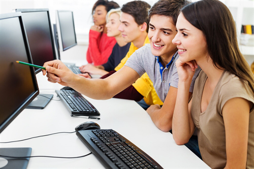 Team collaborating at workstations during software training